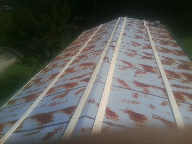 Rusted metal roof panels with new wood purlins before replacement — Storm Damage Roof Repair in Collbran by Roofing Brothers